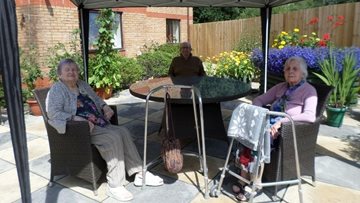 Ammanford care home Resident enjoy time in the garden